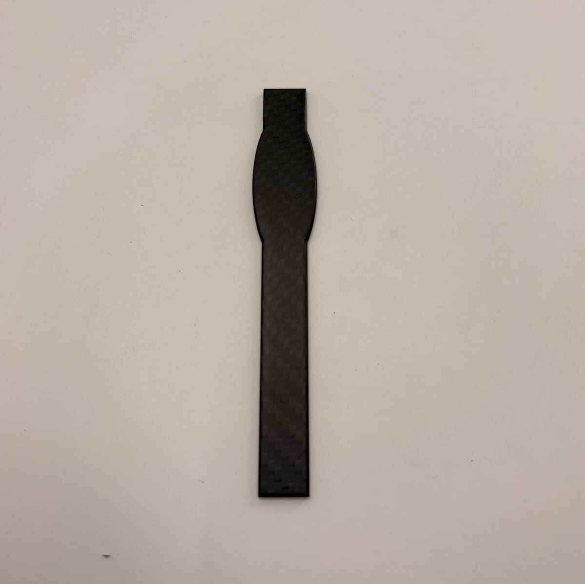 Long CNC-machined matte T300 carbon fiber automotive component.jpg